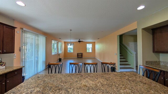 452 Rancho Mirage Rd, Madera, CA 93638 - dining area featuring tile patterned floors, stairs, recessed lighting, ceiling fan, and a textured ceiling