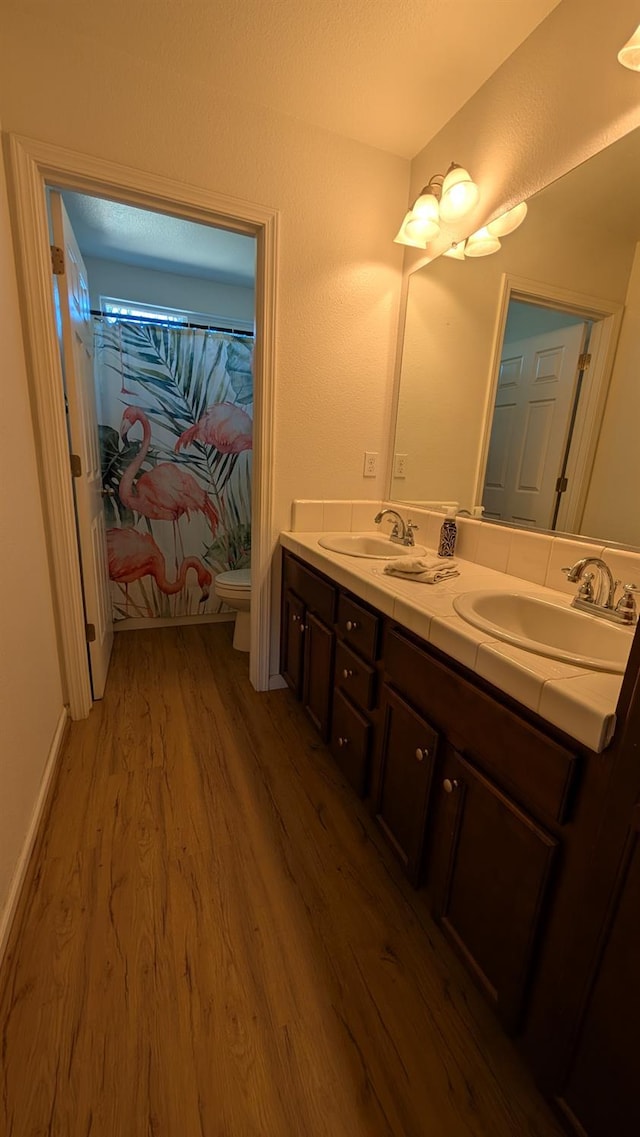 452 Rancho Mirage Rd, Madera, CA 93638 - full bath with wood finished floors, double vanity, and a shower with shower curtain