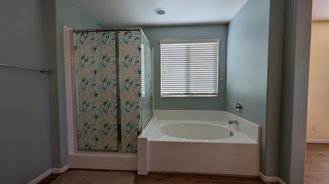 452 Rancho Mirage Rd, Madera, CA 93638 - bathroom with a bath, wood finished floors, and a shower with shower curtain