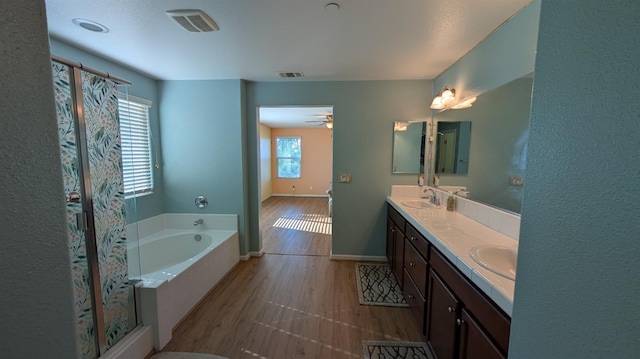 452 Rancho Mirage Rd, Madera, CA 93638 - bathroom featuring double vanity, a garden tub, a stall shower, and a ceiling fan