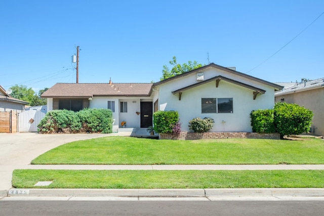 4835 E Normal Ave, Fresno, CA 93703 - ranch-style house with stucco siding, a gate, and driveway