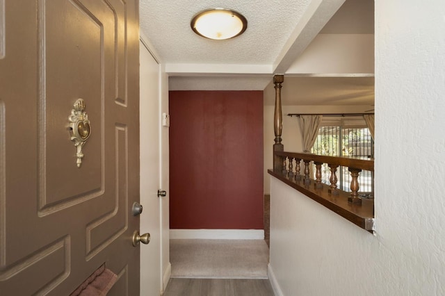 4835 E Normal Ave, Fresno, CA 93703 - corridor featuring a textured ceiling and wood finished floors