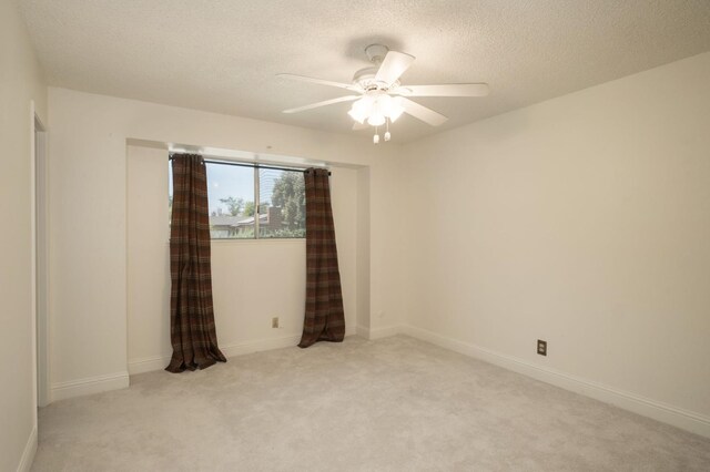 4835 E Normal Ave, Fresno, CA 93703 - spare room featuring carpet flooring, a ceiling fan, and a textured ceiling