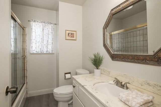 4835 E Normal Ave, Fresno, CA 93703 - full bathroom featuring vanity, enclosed tub / shower combo, and wood finished floors