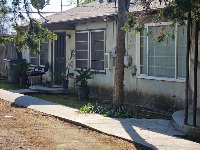 745 E La Sierra, Fresno, CA 93728 - entrance to property featuring stucco siding and roof with shingles