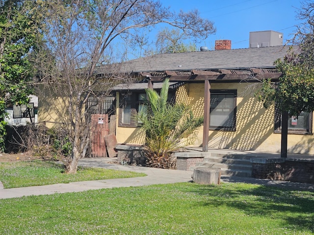 745 E La Sierra, Fresno, CA 93728 - view of front of home featuring a front lawn, roof with shingles, and a chimney