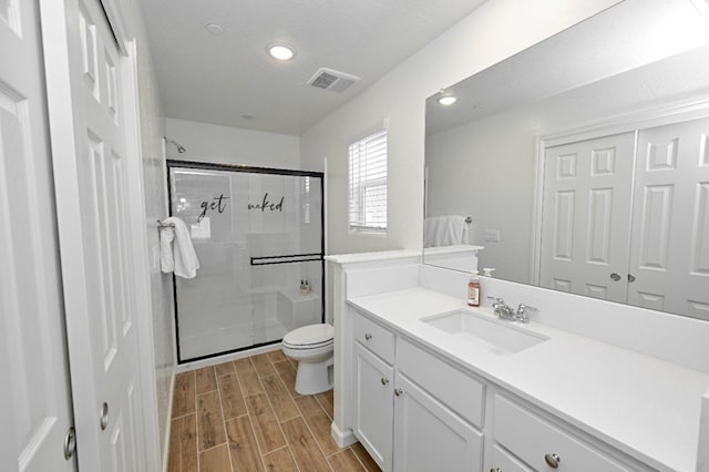 6317 E Malbec Dr, Fresno, CA 93727 - full bathroom featuring a shower stall, wood finished floors, vanity, and recessed lighting