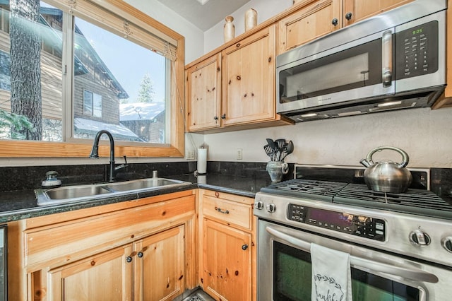 40862 Village Pass Ln, Shaver Lake, CA 93664 - kitchen with appliances with stainless steel finishes, dark countertops, and light brown cabinets