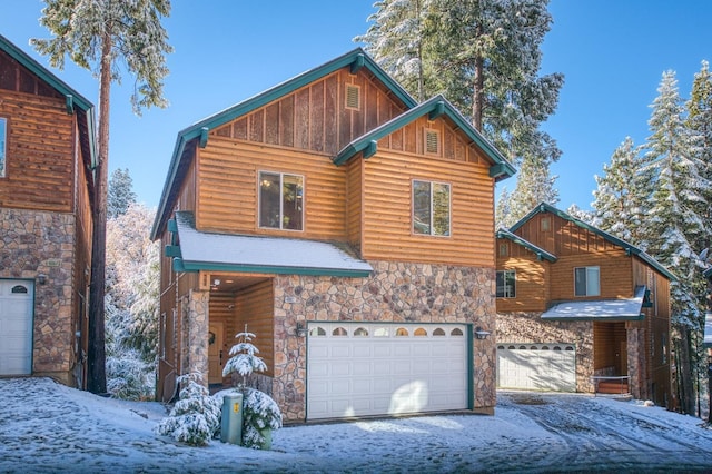 40862 Village Pass Ln, Shaver Lake, CA 93664 - chalet / cabin featuring stone siding, board and batten siding, a garage, and driveway