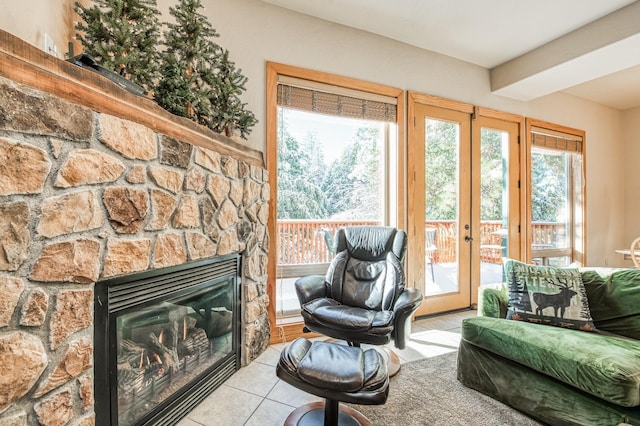 40862 Village Pass Ln, Shaver Lake, CA 93664 - living room with french doors, tile patterned floors, and a stone fireplace