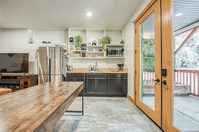40862 Village Pass Ln, Shaver Lake, CA 93664 - kitchen featuring freestanding refrigerator, dark cabinetry, stone finish floors, french doors, and open shelves
