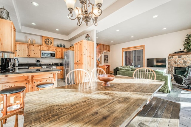 40862 Village Pass Ln, Shaver Lake, CA 93664 - dining room with a chandelier, recessed lighting, and a stone fireplace