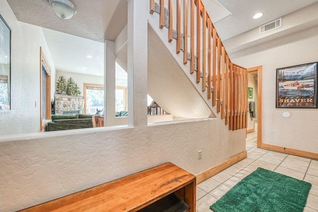 40862 Village Pass Ln, Shaver Lake, CA 93664 - tiled entryway with stairs, a textured wall, and recessed lighting