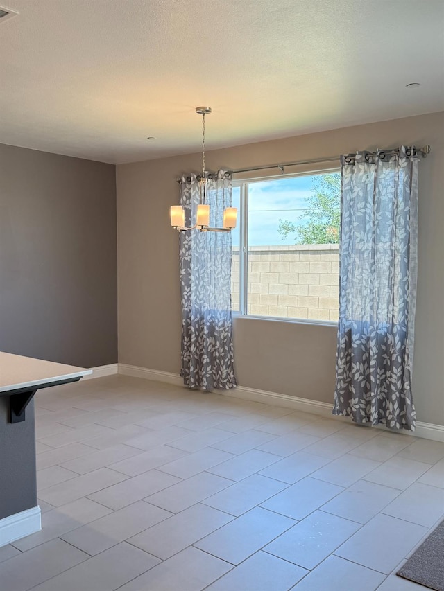 3963 Morris Ave, Clovis, CA 93619 - unfurnished dining area featuring light tile patterned flooring and a chandelier