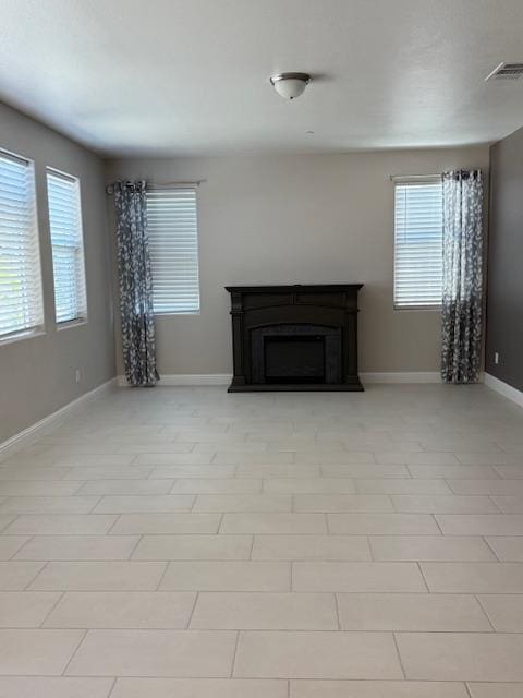 3963 Morris Ave, Clovis, CA 93619 - unfurnished living room featuring baseboards and a fireplace
