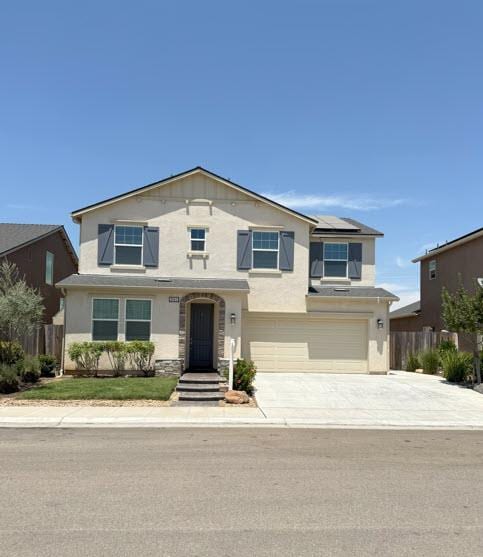 3963 Morris Ave, Clovis, CA 93619 - traditional home with a garage, roof mounted solar panels, driveway, and stucco siding