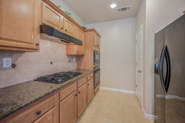 439 W Serena Ave, Clovis, CA 93619 - kitchen with black appliances, under cabinet range hood, backsplash, dark stone countertops, and light tile patterned floors