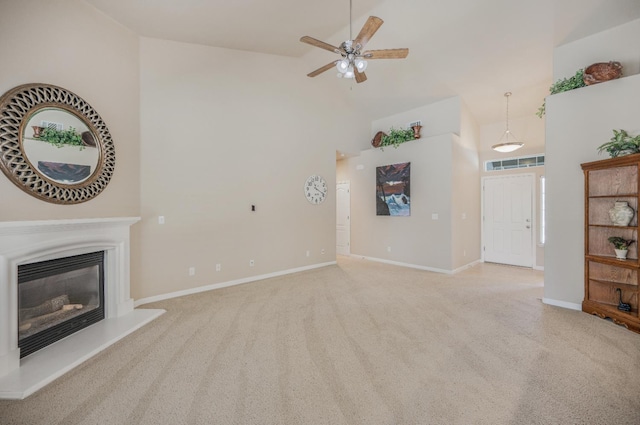 439 W Serena Ave, Clovis, CA 93619 - unfurnished living room with high vaulted ceiling, a ceiling fan, a glass covered fireplace, and light carpet