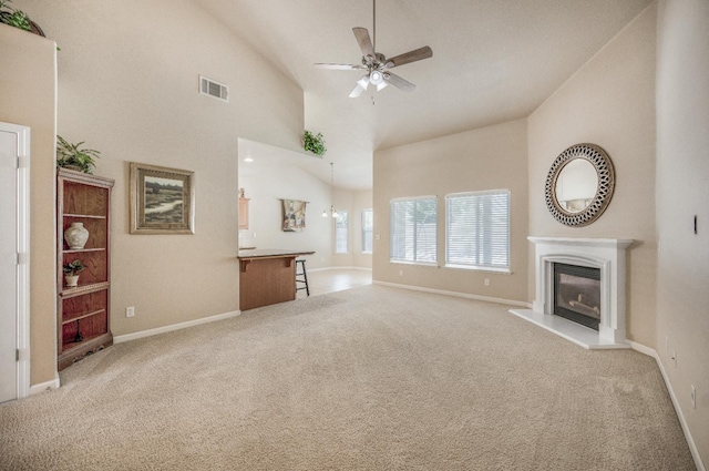 439 W Serena Ave, Clovis, CA 93619 - unfurnished living room with ceiling fan, light carpet, a glass covered fireplace, and lofted ceiling