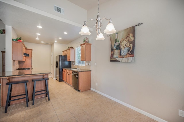 439 W Serena Ave, Clovis, CA 93619 - kitchen with black appliances, a kitchen bar, a chandelier, recessed lighting, and decorative backsplash
