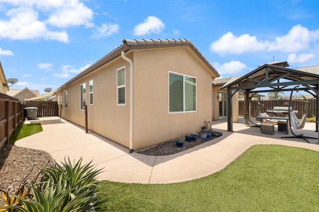 3143 Celeste Ave, Clovis, CA 93619 - rear view of property with a gazebo, a patio area, a fenced backyard, stucco siding, and a tile roof