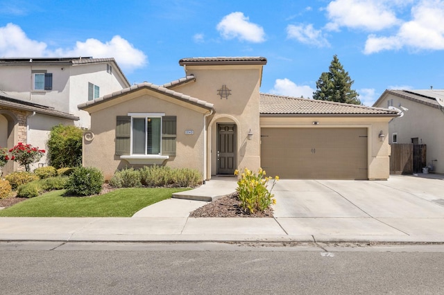 3143 Celeste Ave, Clovis, CA 93619 - mediterranean / spanish-style home featuring an attached garage, stucco siding, a tile roof, driveway, and a front yard