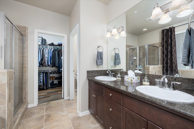 3143 Celeste Ave, Clovis, CA 93619 - bathroom featuring a shower stall, double vanity, a walk in closet, and tile patterned flooring