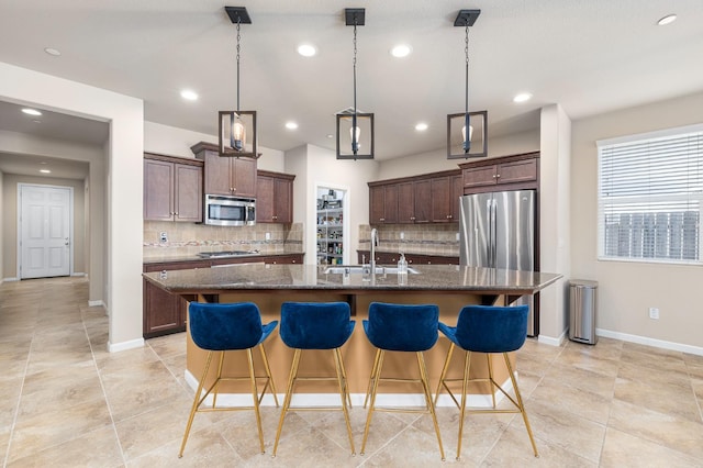 3143 Celeste Ave, Clovis, CA 93619 - kitchen with stainless steel appliances, decorative backsplash, a kitchen breakfast bar, and recessed lighting