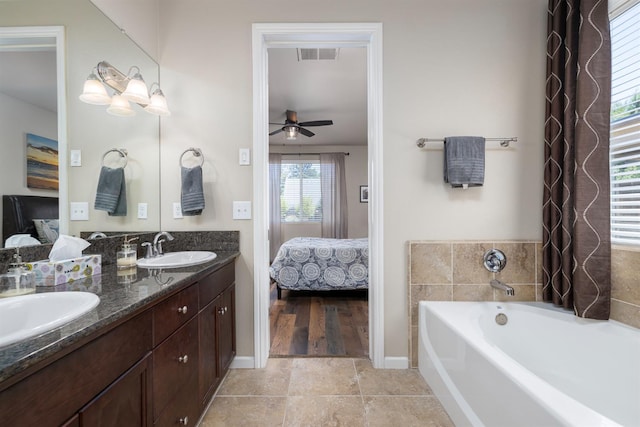 3143 Celeste Ave, Clovis, CA 93619 - bathroom with connected bathroom, double vanity, a garden tub, ceiling fan, and tile patterned flooring