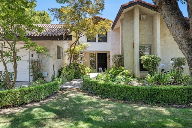 5630 N El Adobe Dr, Fresno, CA 93711 - view of front of property with a tile roof, stucco siding, and a front yard