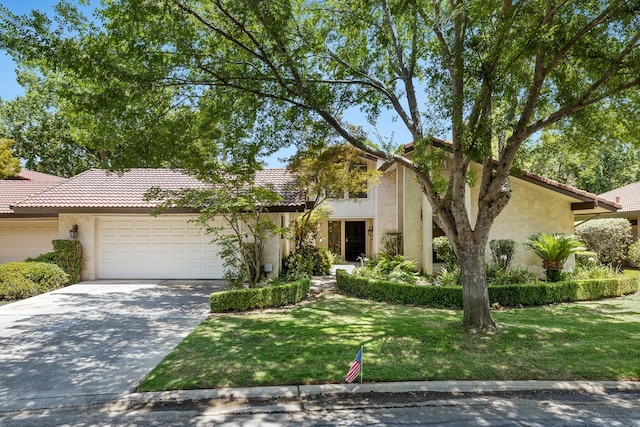 5630 N El Adobe Dr, Fresno, CA 93711 - view of front facade featuring stucco siding, an attached garage, a tiled roof, and concrete driveway