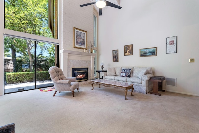 5630 N El Adobe Dr, Fresno, CA 93711 - living room with a towering ceiling, carpet flooring, a premium fireplace, and ceiling fan