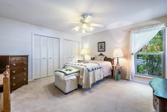 5630 N El Adobe Dr, Fresno, CA 93711 - bedroom featuring multiple closets, light carpet, and a ceiling fan