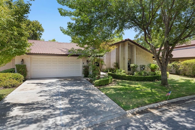 5630 N El Adobe Dr, Fresno, CA 93711 - view of front of home featuring stucco siding, driveway, a garage, a tiled roof, and a front lawn