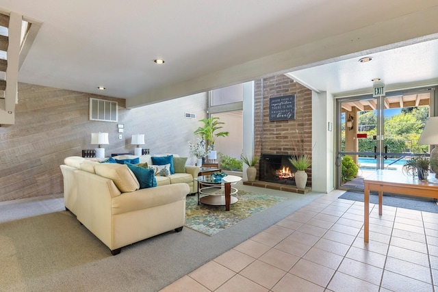 5630 N El Adobe Dr, Fresno, CA 93711 - living room featuring a brick fireplace, light tile patterned flooring, light colored carpet, and recessed lighting
