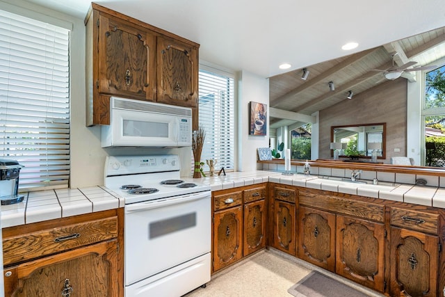 5630 N El Adobe Dr, Fresno, CA 93711 - kitchen with white appliances, wooden ceiling, ceiling fan, and brown cabinetry