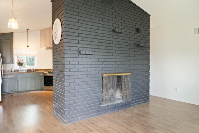 1016 N White, Hanford, CA 93230 - unfurnished living room featuring light wood-style floors and a fireplace