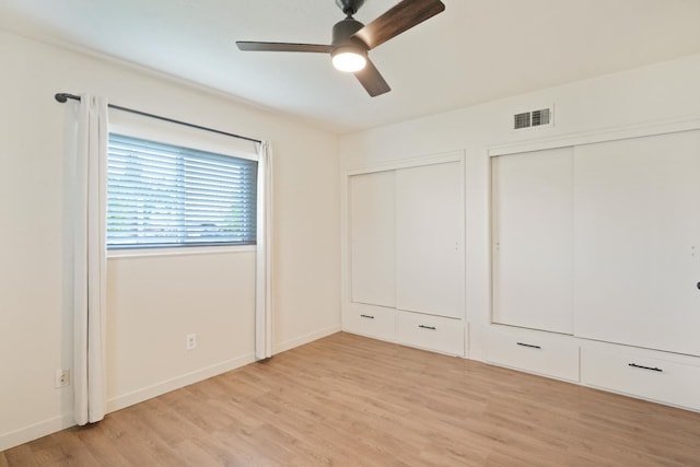 1016 N White, Hanford, CA 93230 - unfurnished bedroom with multiple closets, light wood-style flooring, and ceiling fan