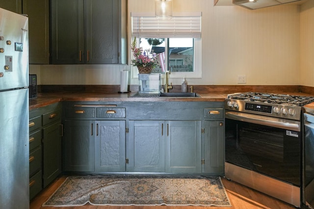 1016 N White, Hanford, CA 93230 - kitchen featuring appliances with stainless steel finishes and wood finished floors