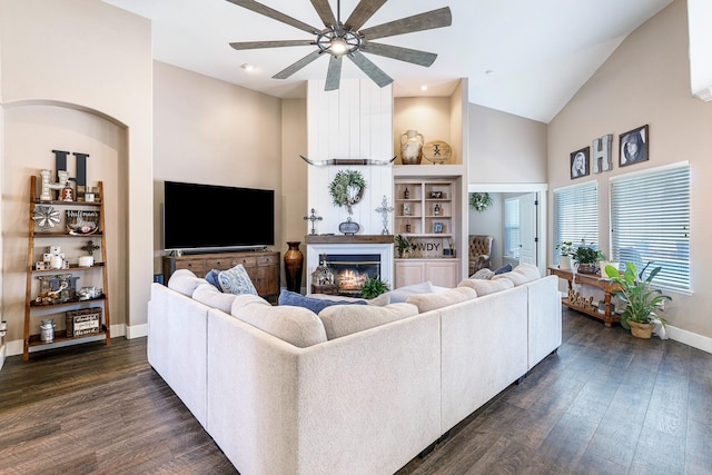 8194 N 5th St, Fresno, CA 93720 - living area with ceiling fan, high vaulted ceiling, dark wood-style flooring, and a warm lit fireplace