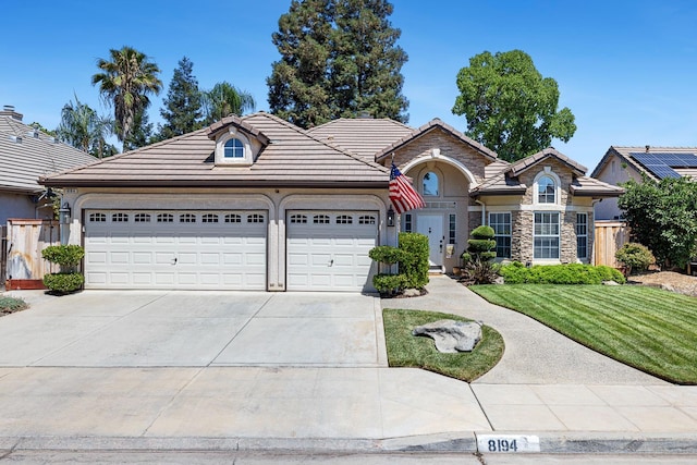 8194 N 5th St, Fresno, CA 93720 - ranch-style house with an attached garage, concrete driveway, a tile roof, stucco siding, and stone siding