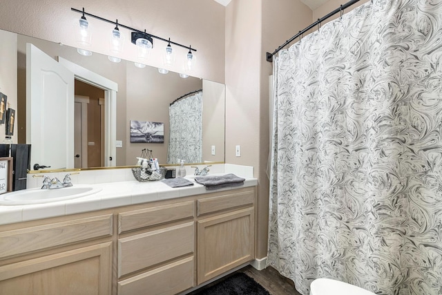 8194 N 5th St, Fresno, CA 93720 - bathroom featuring double vanity and wood finished floors