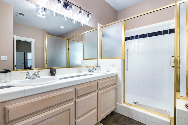 8194 N 5th St, Fresno, CA 93720 - bathroom with a shower stall, double vanity, and wood finished floors