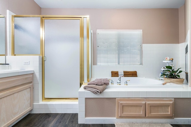 8194 N 5th St, Fresno, CA 93720 - bathroom with vanity, a stall shower, tile walls, a bath, and wood finished floors