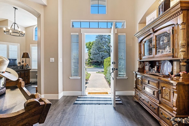 8194 N 5th St, Fresno, CA 93720 - foyer with a chandelier, a towering ceiling, dark wood-type flooring, arched walkways, and plenty of natural light