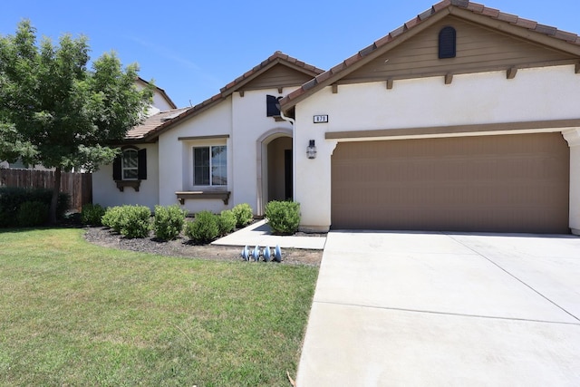 879 Hermosa Ave, Clovis, CA 93619 - view of front of house with stucco siding, a tile roof, concrete driveway, and an attached garage
