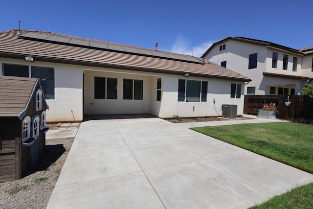 879 Hermosa Ave, Clovis, CA 93619 - back of property with roof mounted solar panels, a tile roof, stucco siding, and a patio area