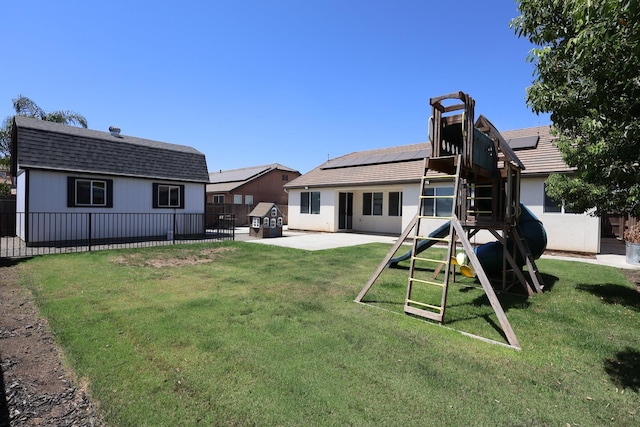 879 Hermosa Ave, Clovis, CA 93619 - rear view of house with a patio area, roof mounted solar panels, and a fenced backyard