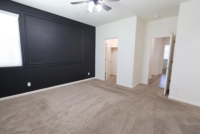 879 Hermosa Ave, Clovis, CA 93619 - unfurnished bedroom with carpet flooring, a walk in closet, a ceiling fan, and a closet