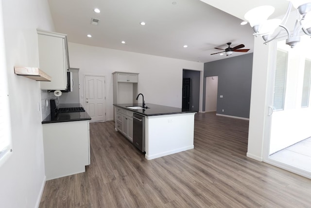879 Hermosa Ave, Clovis, CA 93619 - kitchen featuring dark countertops, wood finished floors, stainless steel dishwasher, ceiling fan, and recessed lighting